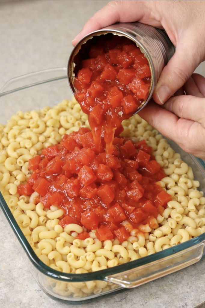 Pour canned tomatoes over uncooked elbow macaroni, along with 2 other ingredients, into a casserole dish for a comforting dinner that’s the first thin